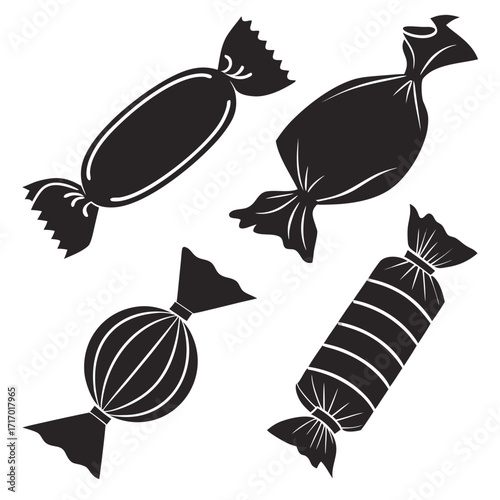 Four Black Wrapped Candies On White Background Keywords: candy, sweet, wrapper, wrapped, treat