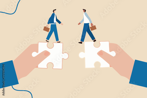 Two business people walking on puzzle pieces held by hands symbolizing teamwork and connection