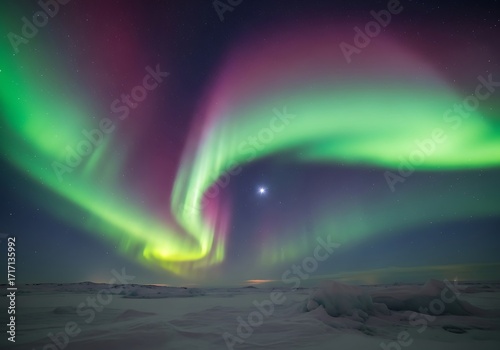 Wallpaper Mural A vibrant display of the aurora borealis, vibrant with hues of green, purple, and pink, dances across a night sky dotted with stars, casting an ethereal glow over a vast expanse of snowy landscape. Torontodigital.ca