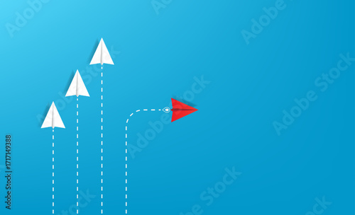 Red paper plane out of line with white papers to change a new way, new idea and innovation concept, courage to stand out and unique