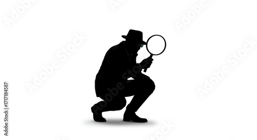 Silhouette of crouching man with a magnifying glass wearing a hat and suit