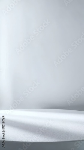 Minimalist white surface with soft shadows and neutral background