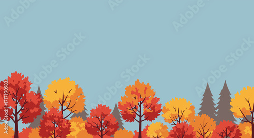Autumn trees against a pale blue sky creating a peaceful scene