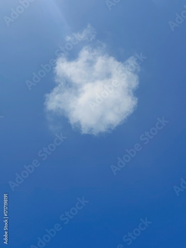 White cloud in a clear blue sky, natural background.