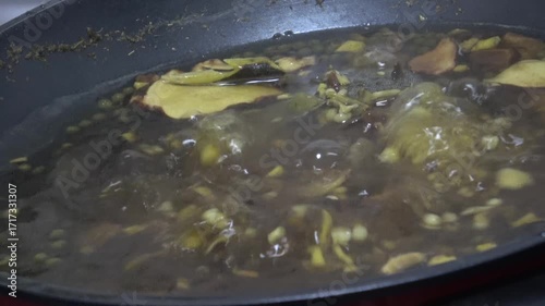 Bubble herbal soup boiling in hot pot.
