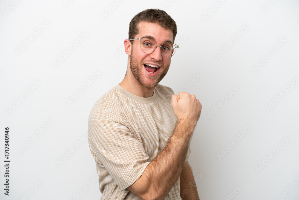 Fototapeta premium Young caucasian man isolated on white background celebrating a victory