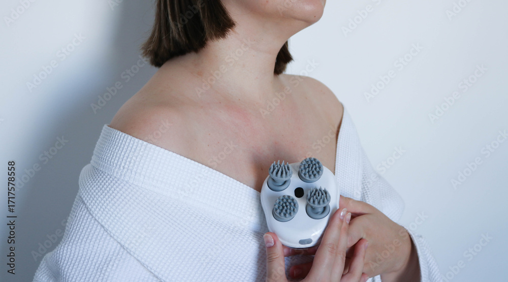 Fototapeta premium Electronic handheld body massager in use
