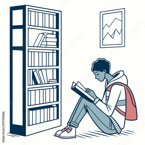 Young student with backpack sitting on floor reading a book next to a tall bookshelf in a room