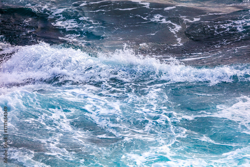 Fototapeta premium The ocean is calm and blue, with a few small waves