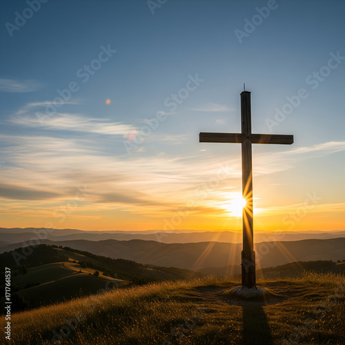 A solitary wooden cross stands silhouetted against a breathtaking sunset over rolling hills, bathed in golden light