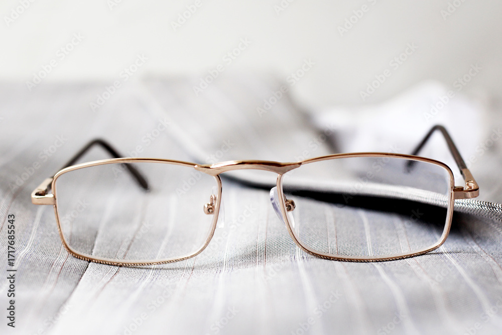 Fotografie Men's reading glasses in a gray jacket.