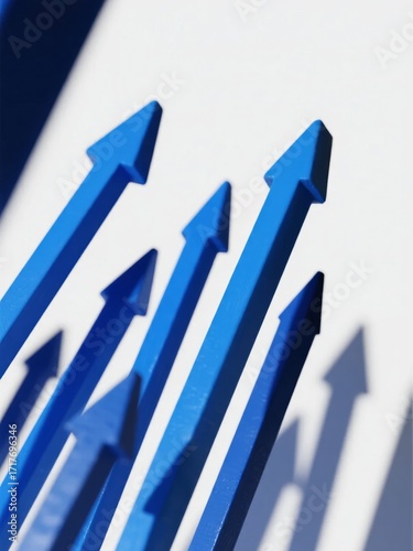 Blue upward-pointing arrows arranged in a row, casting shadows on a white surface