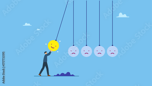 Man holding smile face pendulum ball to hit other sad faces. Optimistic, happiness or positive thinking inspire other people happy, emotional intelligence or balance between happiness and sadness.