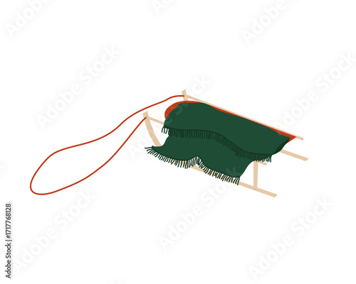 An orange sled with a rope is covered with a cozy green blanket.