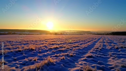 Sunrise over a frosted field covered in snow