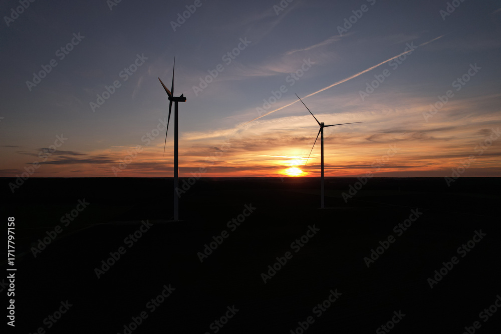 Obraz premium Wind Turbine un front of Sunset, drone View.