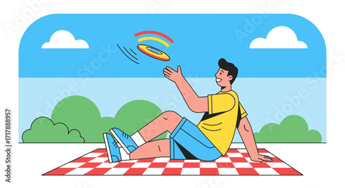 Joyful Young Man Enjoying Outdoor Leisure Activity Playing With Frisbee On Checkered Blanket