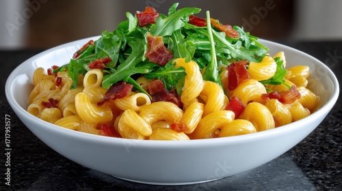 Delicious macroni salad with fresh arugula and crispy bacon ready to be served for a summer gathering or picnic