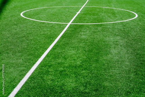 Soccer field with green grass and white line, sport background.