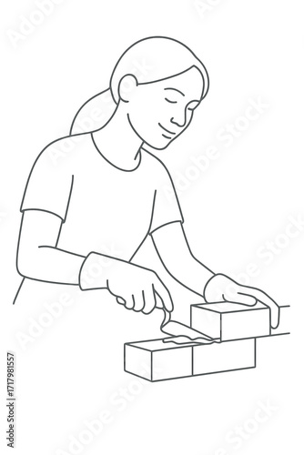 Woman applying mortar between bricks while smiling and working  