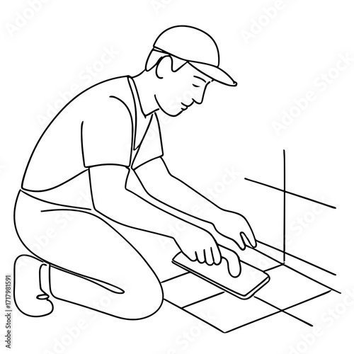 Man applying grout to tiled floor while kneeling in construction site  