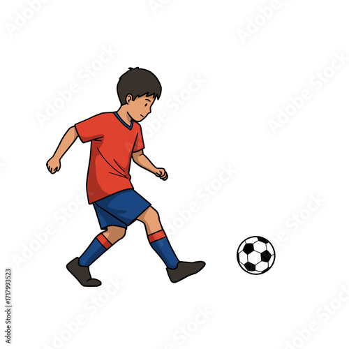 Young boy playing soccer in red and blue uniform on white background  