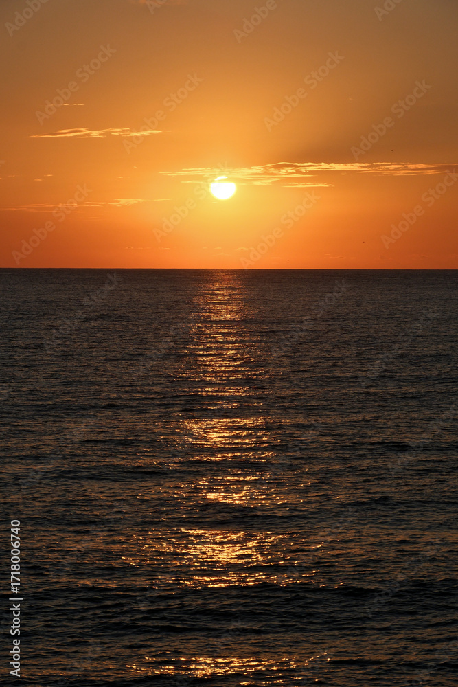 Obraz premium Sunset on the Black Sea in Georgia. Sunset over the sea. Beautiful orange sunset over the sea.