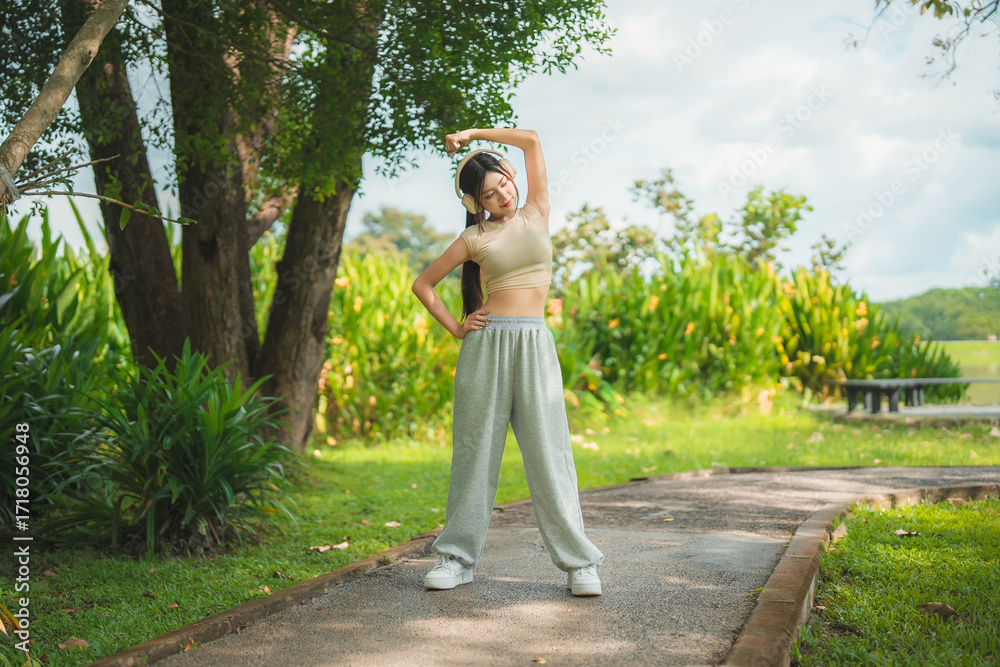 custom made wallpaper toronto digitalA sporty woman in sportswear exercises at the garden