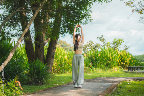 Wallpaper Mural A sporty woman in sportswear exercises at the garden Torontodigital.ca
