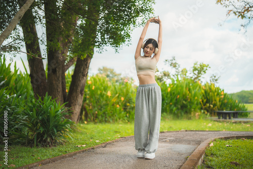 Wallpaper Mural A sporty woman in sportswear exercises at the garden Torontodigital.ca