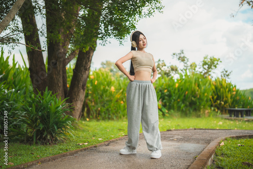 Wallpaper Mural A sporty woman in sportswear exercises at the garden Torontodigital.ca