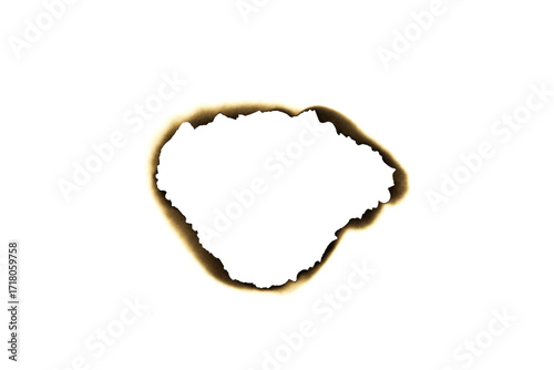 Burnt irregular hole in paper with dark edges isolated on white background with clipping path.