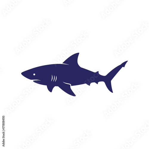 Silhouette of a dark blue shark swimming in the ocean.