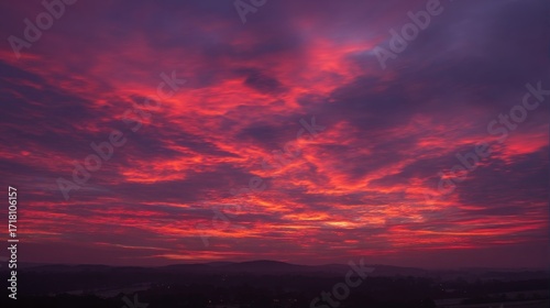 Striking sunset sky with vibrant red and orange hues, dynamic cloud formations,
