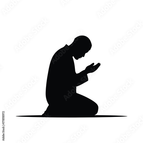Silhouette of a person praying on their knees in a devotional posture