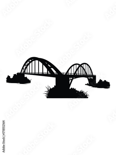 Silhouette of a large arch bridge spanning across a river