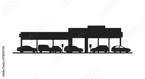 Silhouetted cars at a gas station under a covered structure