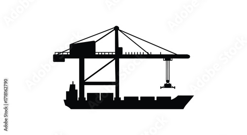 Silhouette of a large ship being loaded by a port container crane