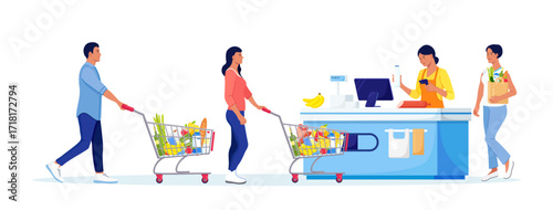 Customers stand in line at grocery supermarket with goods in shopping trolley. Woman put buys on cashier desk for paying. Queue in Store. Grocery Purchases