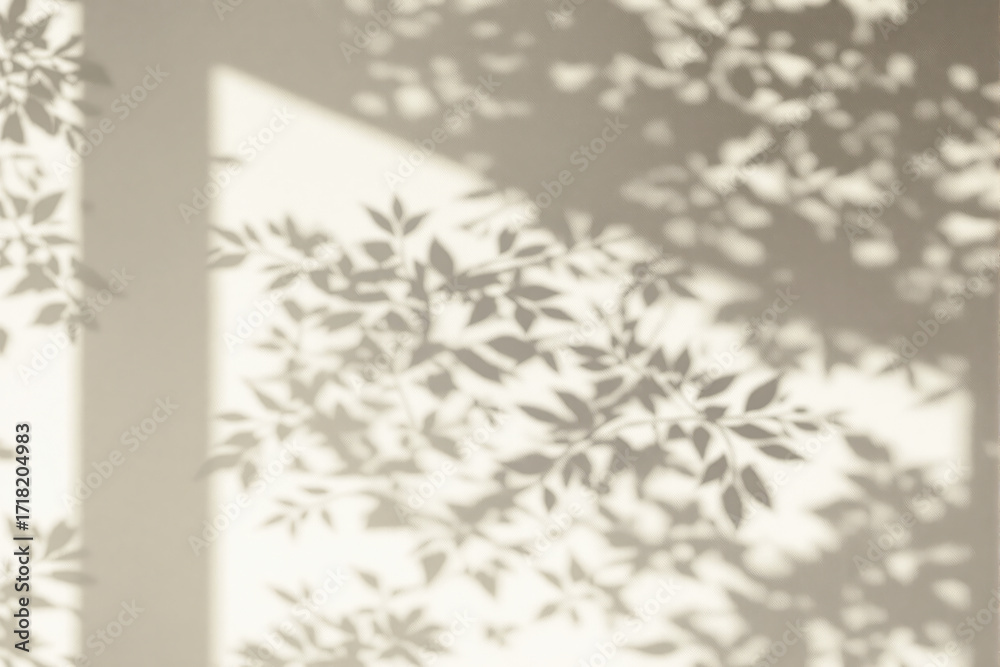 Obraz premium Soft leafy shadows cast on a beige wall with sunlight filtering through, creating a peaceful minimalist nature-inspired design concept background. Ai generative
