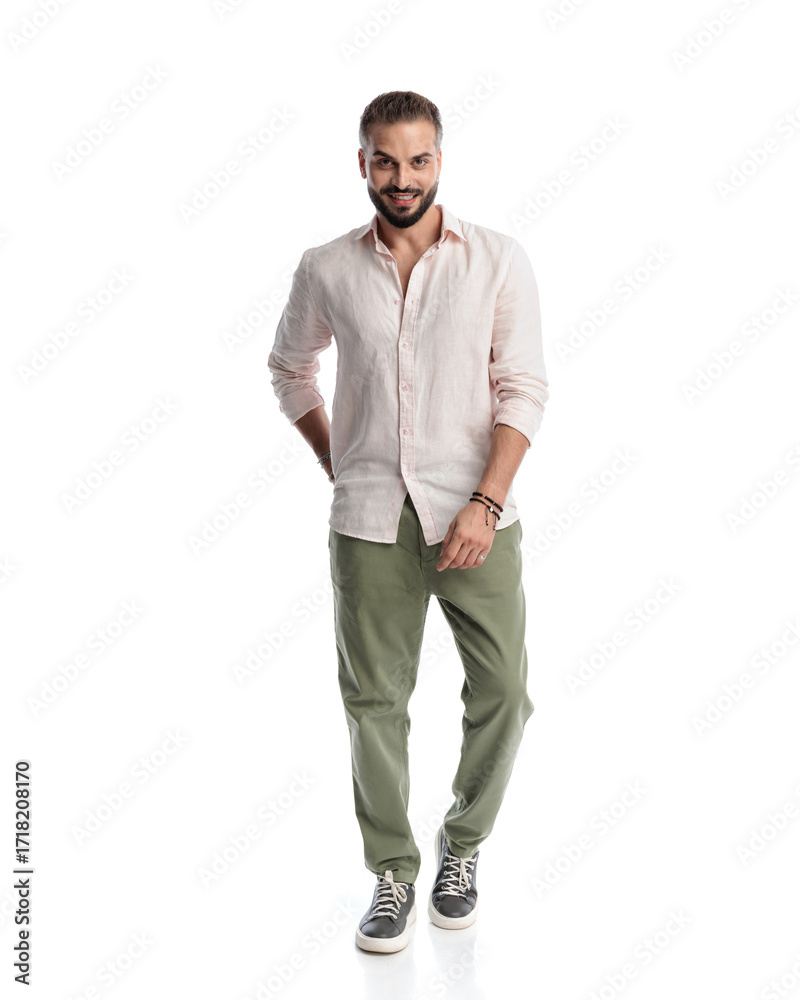 Fototapeta premium happy young man looking forward and smiling while walking