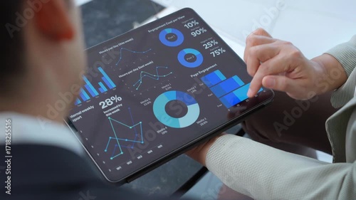 Business colleagues review data on a tablet, discussing performance metrics, market trends, and strategic insights for informed decision making