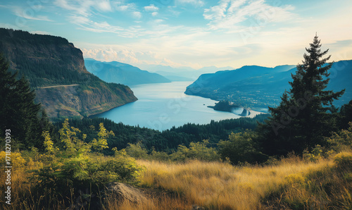 Scenic view of river valley and mountains, lush greenery, tranquil water, golden grass, dramatic sky, distant hills, detailed image