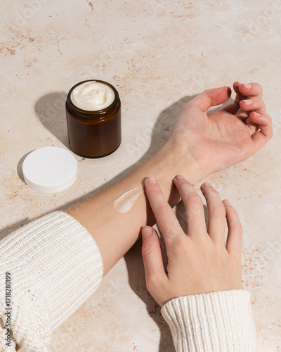 Woman using beef tallow moisturizer with swipe on arm