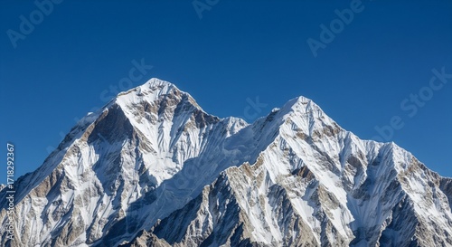 Snow capped mountain peak majestic view Landscape photography Clear blue sky background High altitude scenery