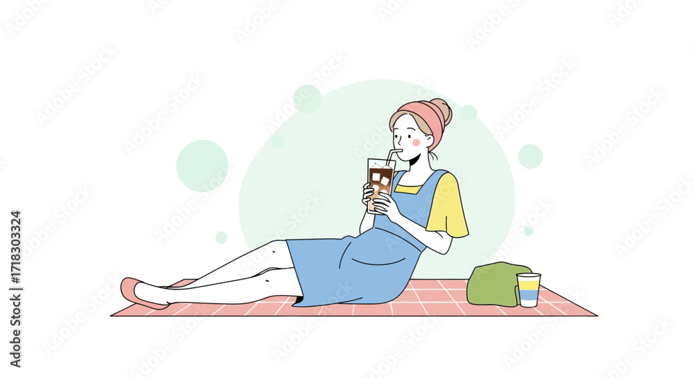 Obraz premium Relaxed Woman Sipping Iced Coffee on Picnic Blanket During Leisure Time Outdoors