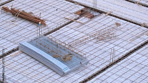 Construction Materials Precast Reinforced Concrete Ceiling Block Slabs and Rusty Stirrup Rebar Reinforcement Rods on Office Residential Building Construction Site