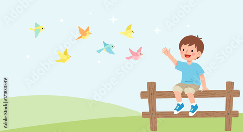 Smiling Young Boy Waving At Colorful Birds While Sitting On A Wooden Fence