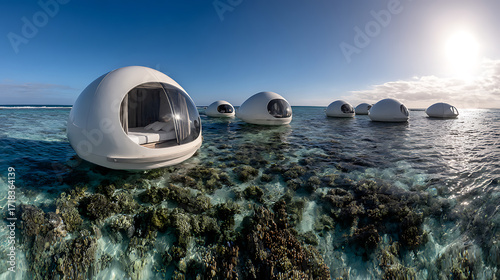 Fototapeta Naklejka Na Ścianę i Meble -  Floating spherical habitats on a coral reef in clear tropical waters under a bright blue sky