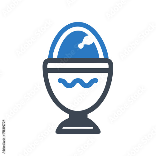 Blue egg in a decorative egg cup on white background  